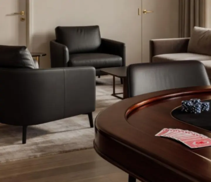Close-up of a poker table with cards, chips and linen-textured surfaces in a premium lounge